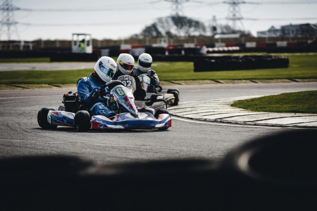 Competitive go-kart race on an outdoor track, showcasing speed and skill.